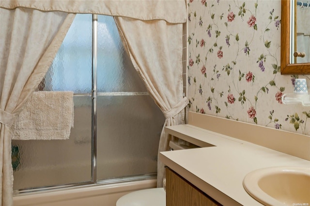 full bathroom with shower / bath combination with glass door, vanity, and toilet