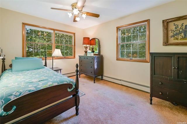 carpeted bedroom featuring ceiling fan, baseboard heating, and multiple windows