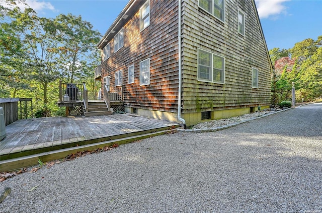 view of side of home featuring a wooden deck