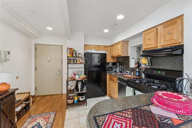 kitchen featuring light brown cabinets, backsplash, black appliances, sink, and light hardwood / wood-style flooring