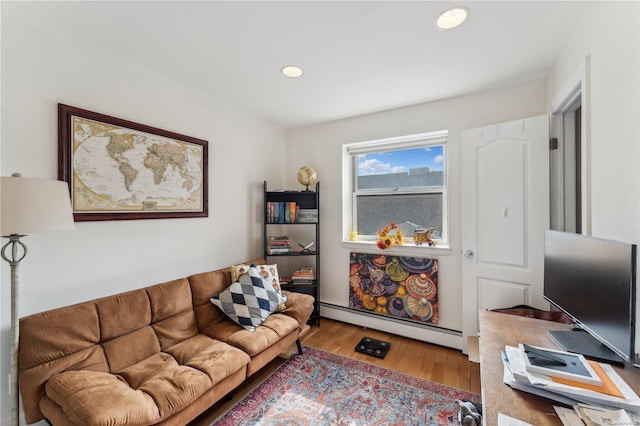 living room with hardwood / wood-style floors and a baseboard heating unit