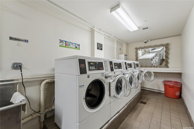 laundry room with tile patterned flooring and washer and clothes dryer