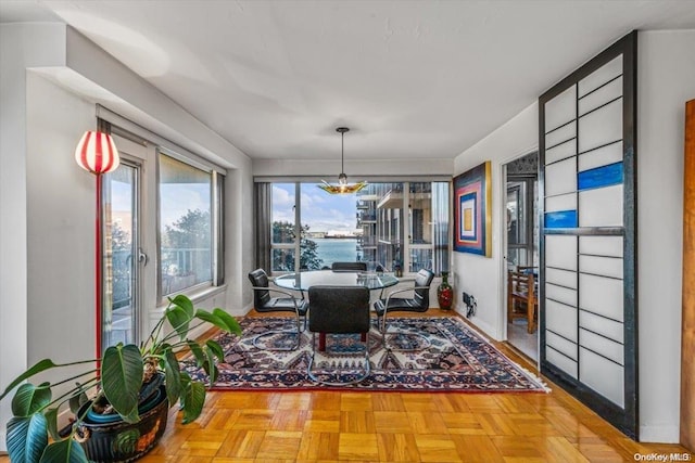 dining area featuring parquet flooring