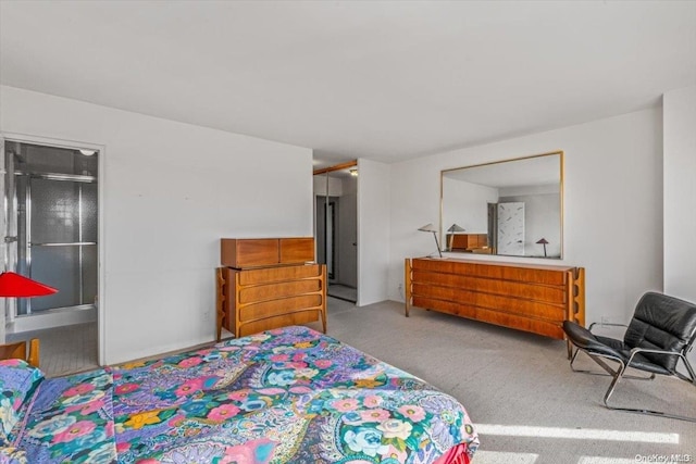 bedroom featuring connected bathroom and light colored carpet