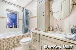 full bathroom featuring vanity, toilet, and shower / bathtub combination with curtain