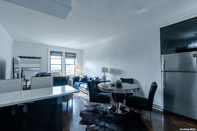 dining area with dark hardwood / wood-style flooring and ornamental molding