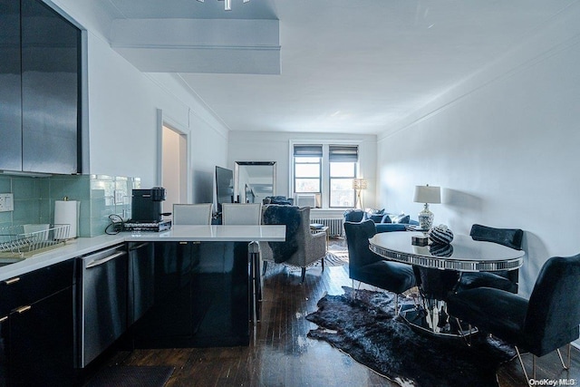 kitchen featuring dark hardwood / wood-style flooring, backsplash, a breakfast bar, crown molding, and dishwasher