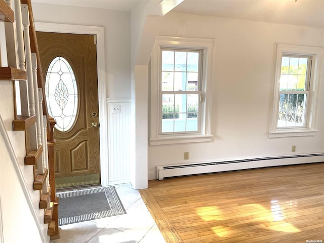 entrance foyer with a healthy amount of sunlight and a baseboard heating unit