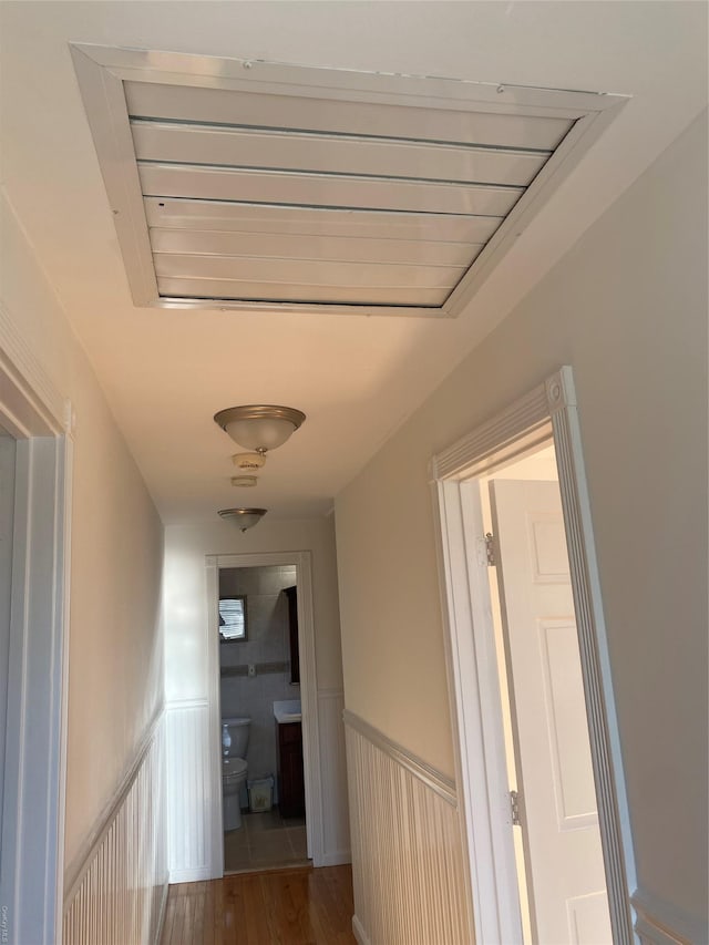 hallway with hardwood / wood-style floors