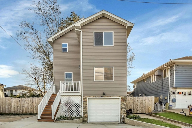 rear view of property featuring a garage