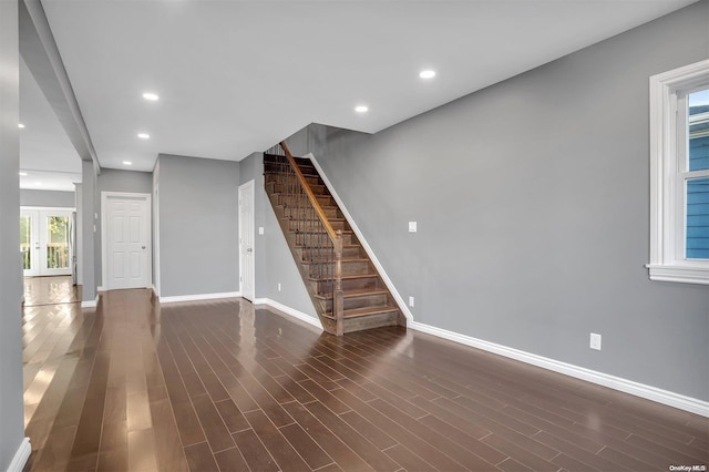 unfurnished living room with dark wood-type flooring