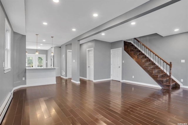 unfurnished living room featuring baseboard heating and dark wood-type flooring