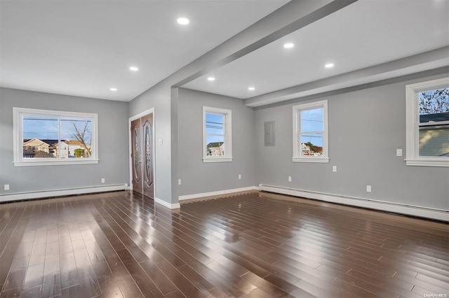 unfurnished living room with baseboard heating and dark wood-type flooring