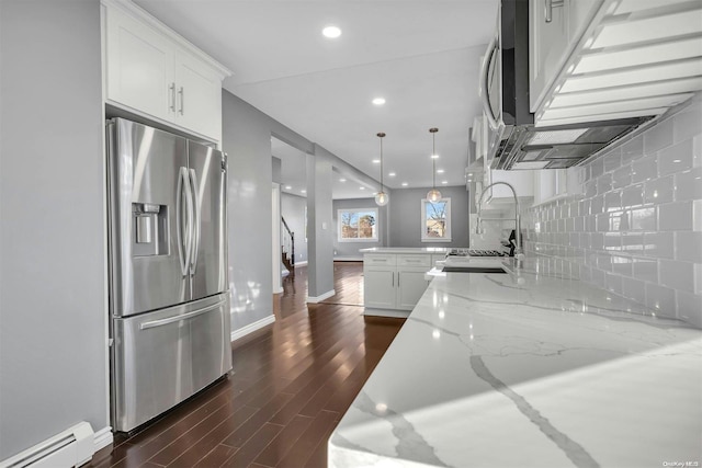 kitchen with light stone counters, a baseboard heating unit, white cabinets, stainless steel fridge with ice dispenser, and dark hardwood / wood-style floors