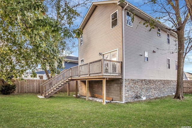 back of house with a yard and a wooden deck