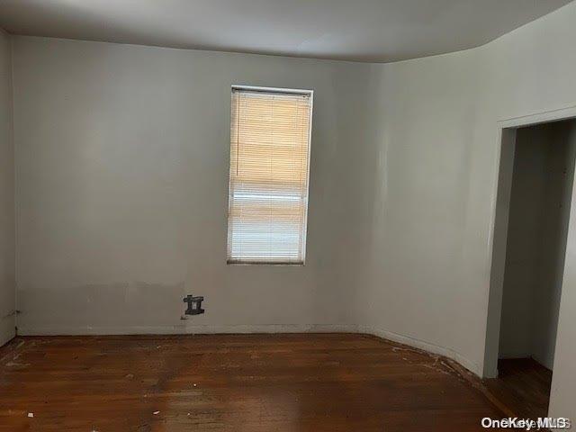 unfurnished room featuring dark hardwood / wood-style floors