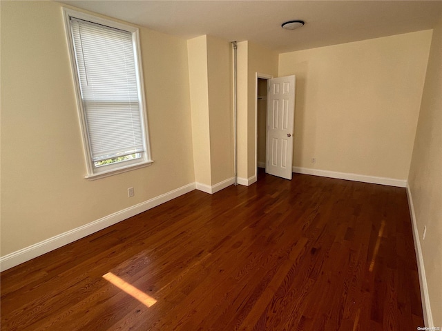 empty room featuring dark hardwood / wood-style flooring