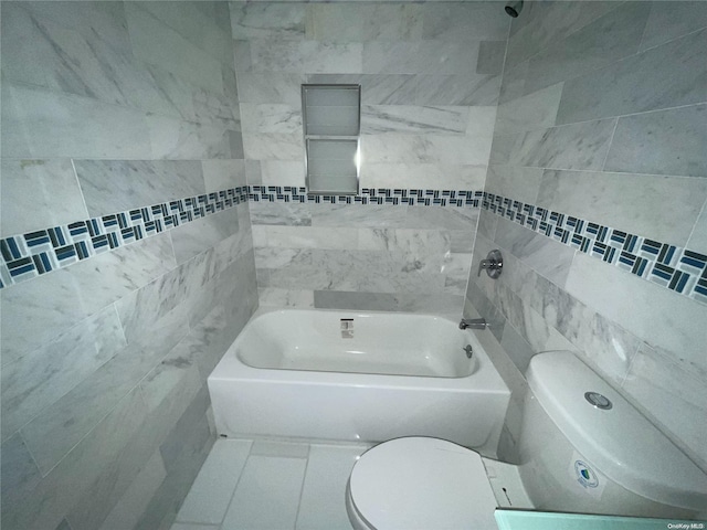 bathroom featuring toilet and tile walls