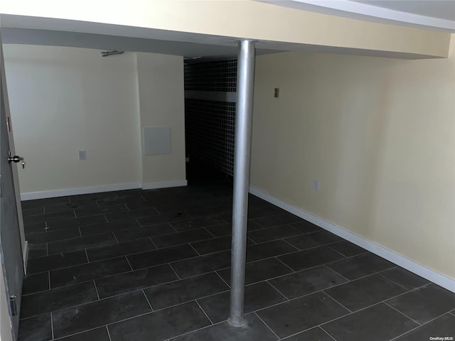 basement with dark tile patterned flooring