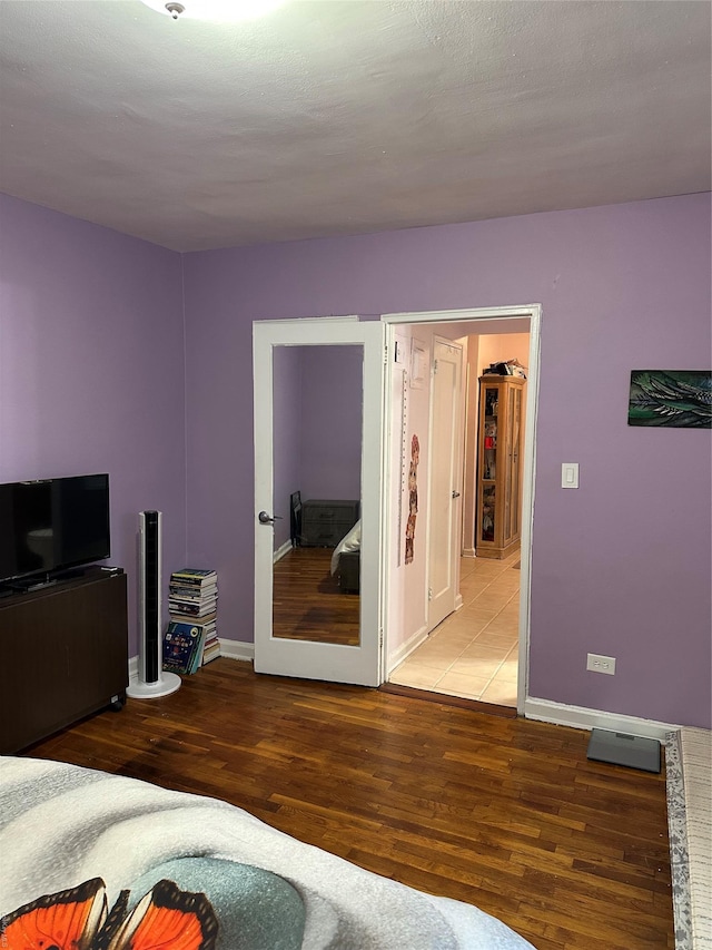 bedroom with hardwood / wood-style flooring