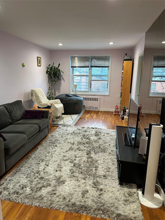 living room with radiator heating unit and light wood-type flooring