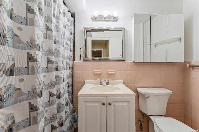 bathroom featuring vanity, toilet, tile walls, and curtained shower