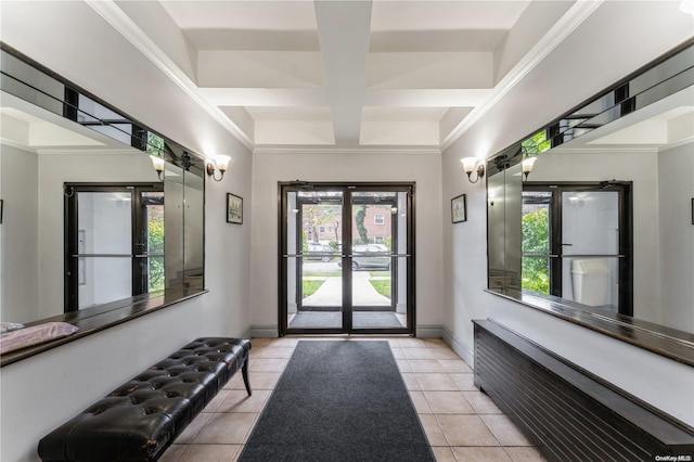 interior space with french doors, light tile patterned flooring, coffered ceiling, and ornamental molding