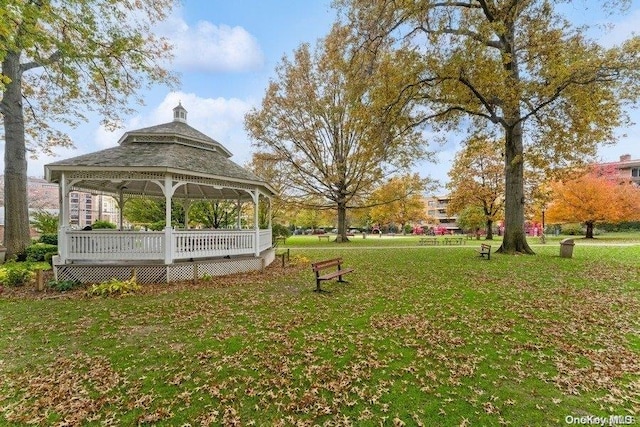 view of property's community with a gazebo, a yard, and a wooden deck