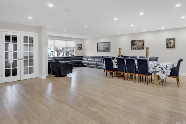 dining area with light hardwood / wood-style flooring and french doors