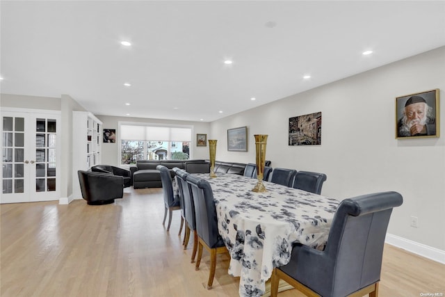 dining area featuring french doors and light hardwood / wood-style floors