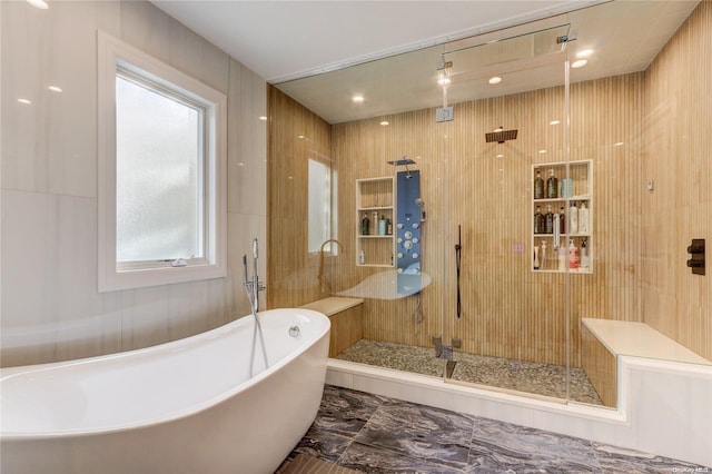 bathroom featuring plus walk in shower and a wealth of natural light