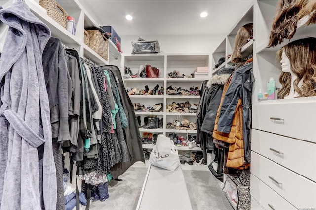 walk in closet featuring light colored carpet