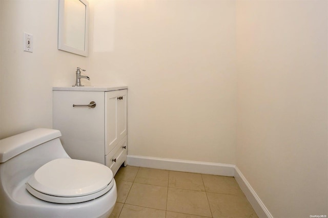 bathroom with tile patterned flooring, vanity, and toilet