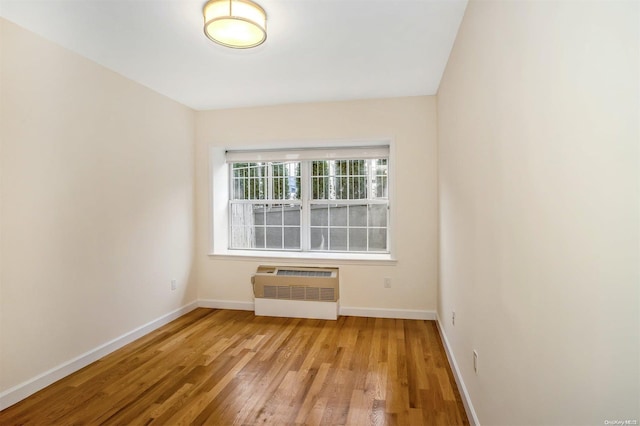 spare room with light hardwood / wood-style flooring and a wall mounted AC