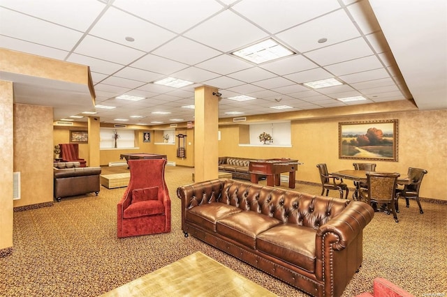 living room with carpet flooring and a paneled ceiling