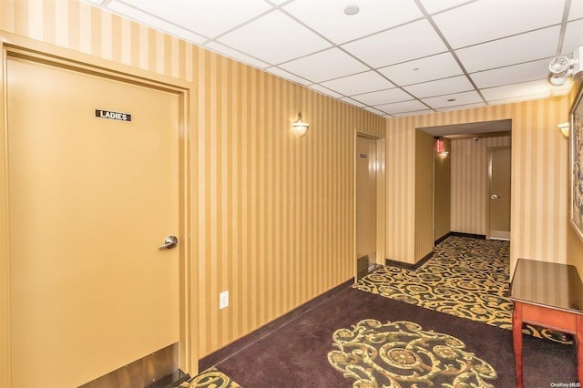 hallway with a drop ceiling