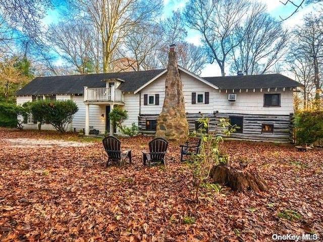 rear view of property with a balcony