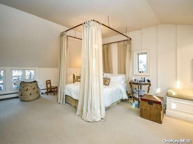 bedroom featuring carpet flooring, multiple windows, and lofted ceiling