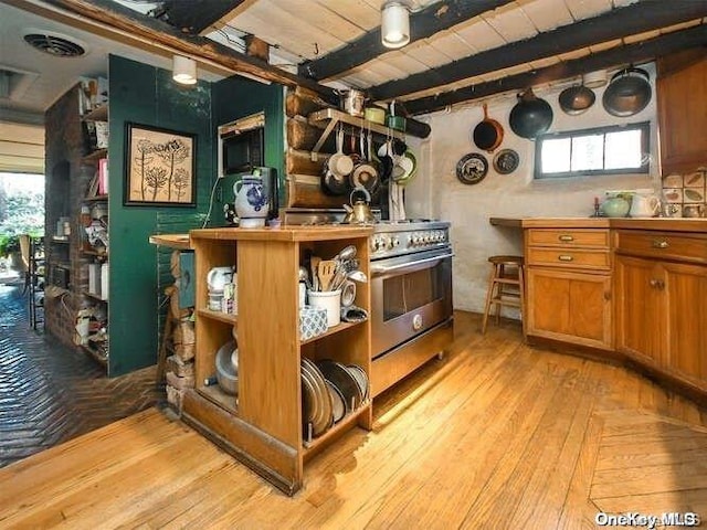 143 Piping Rock Rd, Locust Valley, NY 11560 - bar area featuring high end stainless steel range oven, light wood-type flooring, and wood ceiling with exposed beams