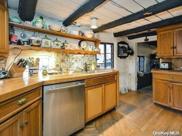 kitchen featuring butcher block counters, dishwasher, sink, beamed ceiling, and light hardwood / wood-style floors