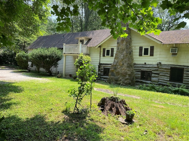 143 Piping Rock Rd, Locust Valley, NY 11560 - view of property exterior featuring a lawn, a shingled roof, and an AC wall unit