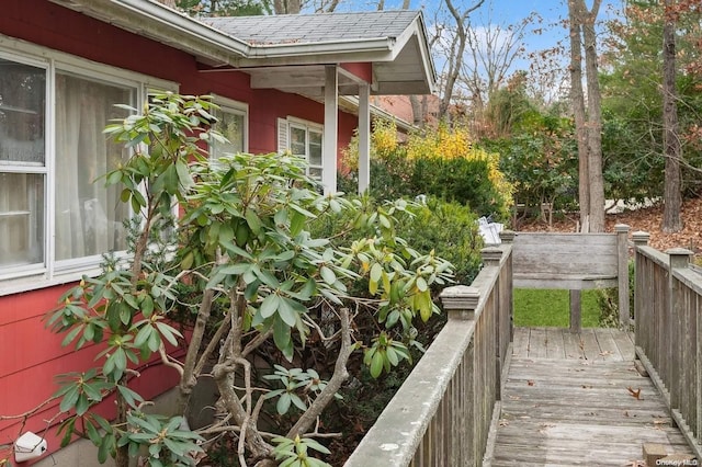 view of property exterior with a wooden deck