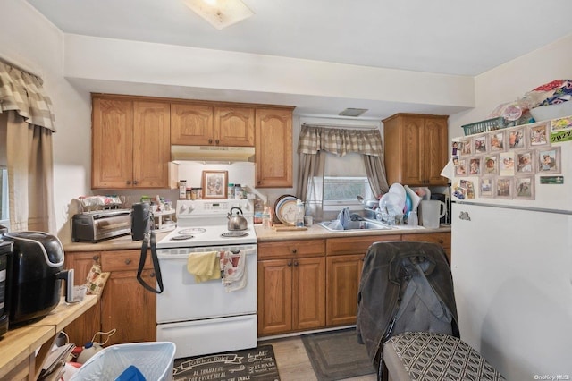 kitchen with white electric range oven and sink