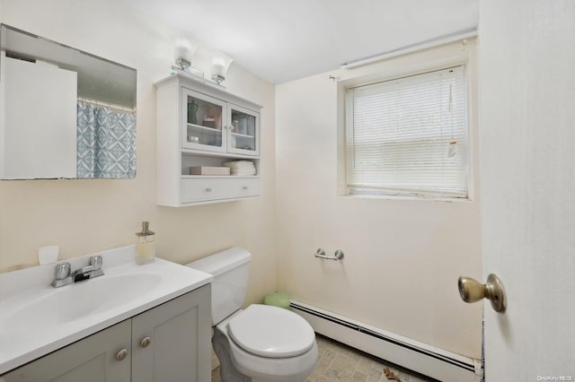 bathroom with vanity, toilet, and a baseboard radiator