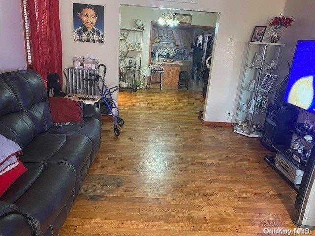 living room featuring hardwood / wood-style floors and an inviting chandelier