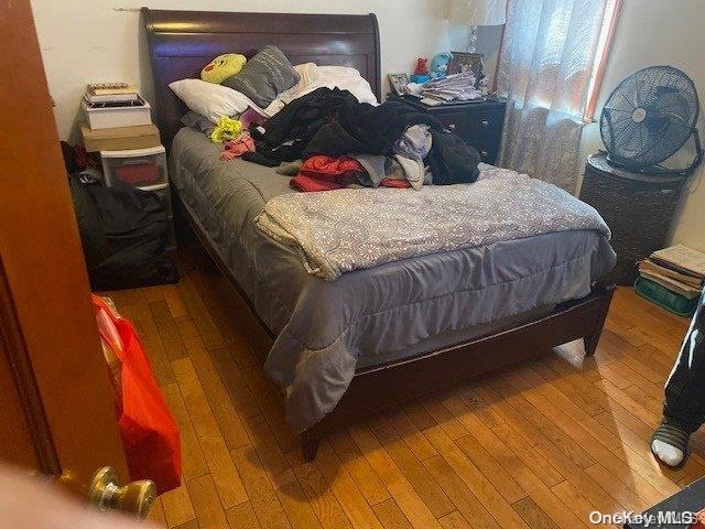 bedroom with hardwood / wood-style flooring