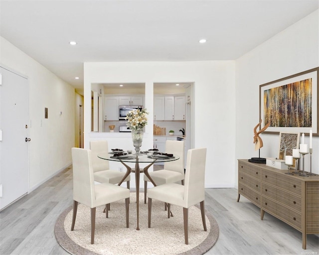 dining space featuring light wood-type flooring