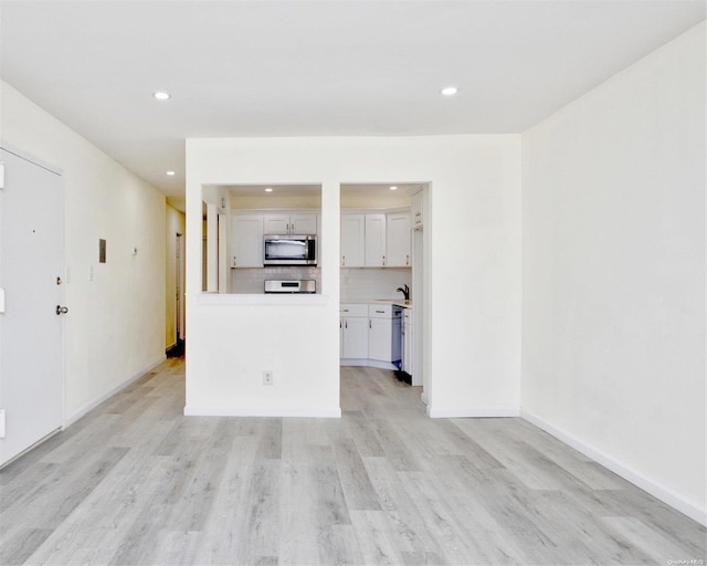 unfurnished living room with light wood-type flooring