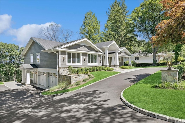 view of front of house with a front yard and a garage