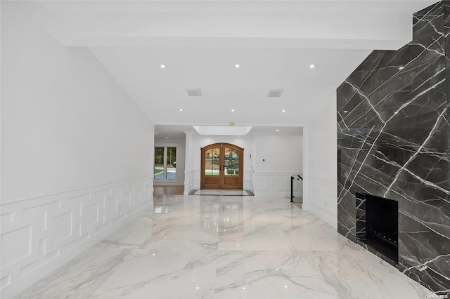 hallway featuring beam ceiling and french doors